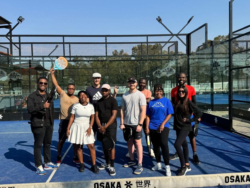 Precious with a group of padel players on court